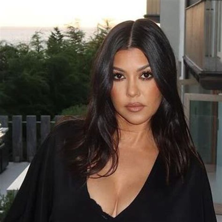Kourtney's bare thigh was exposed when she knelt down to interact with the cat in the snap