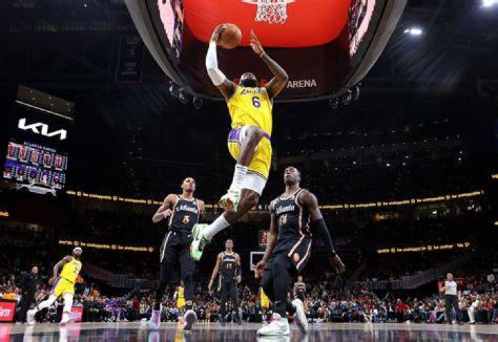 LeBron ahead of a basketball match, with taped ankles and where his overlapping toe is visible on his left foot