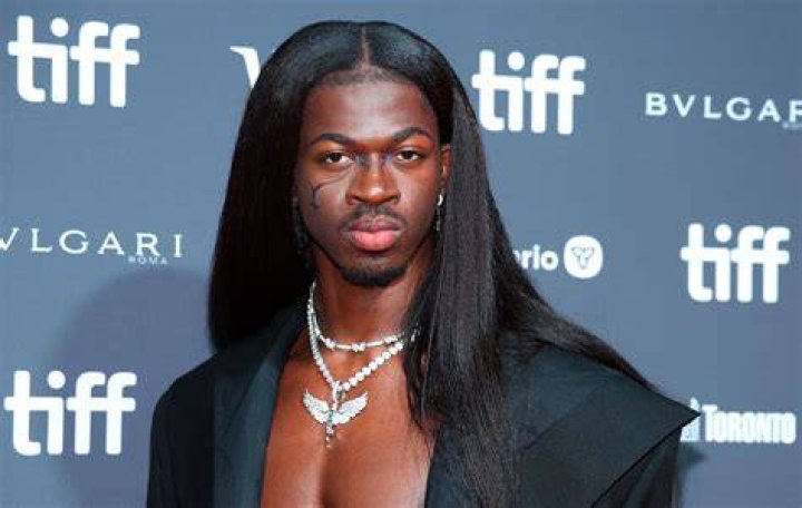 Lil Nas X arrived in a gold Atelier Versace cloak with a long train that followed