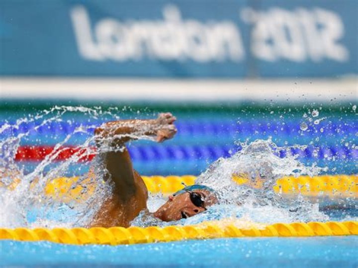  London, pictured swimming, suffered a cardiac arrest as she flew down the slide
