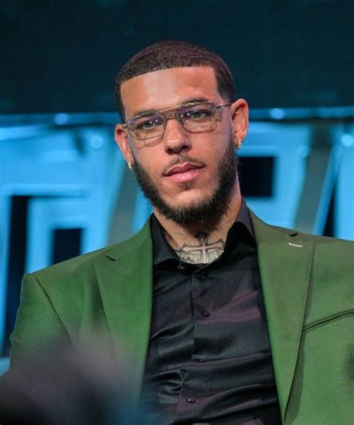 Lonzo Ball matches his suit to his Lamborghini Urus