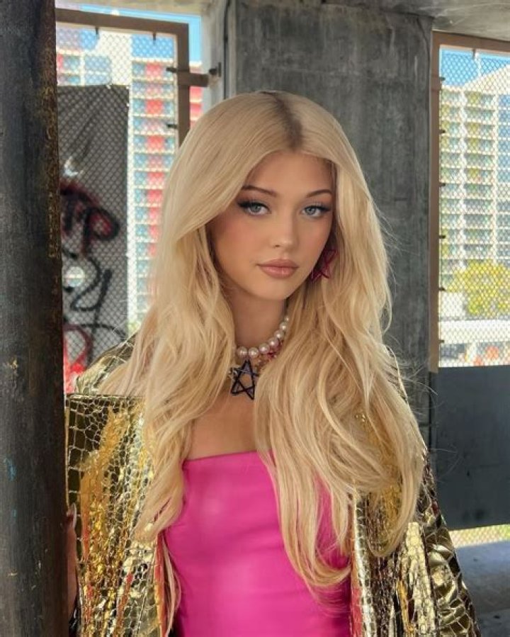 Loren Grey pictured posing with a Range Rover on her Twitter