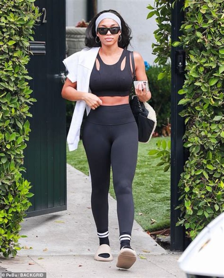 Lori Harvey showed off her chiseled abs and toned physique in a new photo that showed her lounging by the pool in an outdoor bed