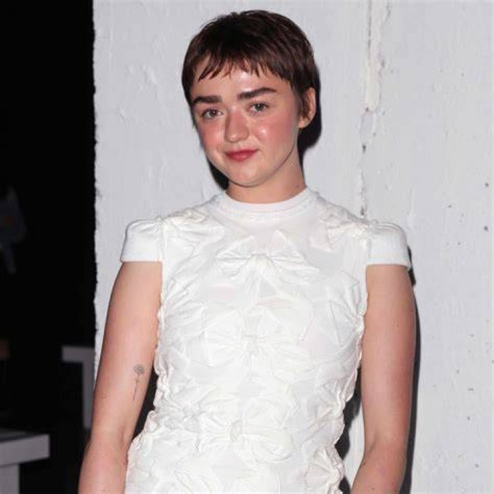 Maise Williams stunned in a Thom Browne dress and matching dark makeup