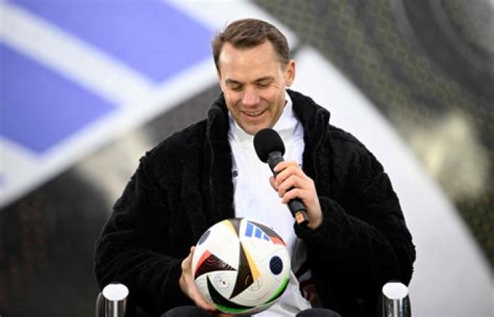 Manuel Neuer clutches the newly-unveiled ball