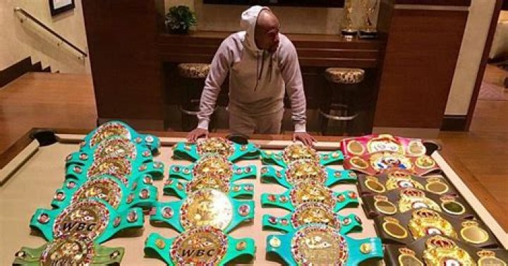 Mayweather shows off two belts designed by Sahaghian, including the WBC belt