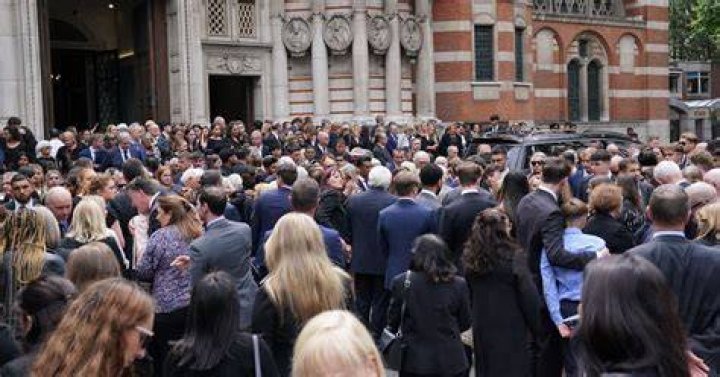 Mourners gather outside the office where Dr Dodson was killed