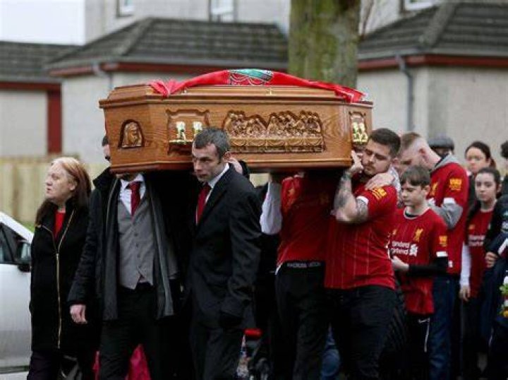 Mourners were pictured leaving red heart balloons on the gate surrounding the property