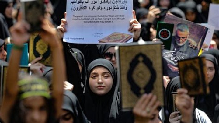 Muslims in Lebanon wield large knives as they cut the tops of their heads