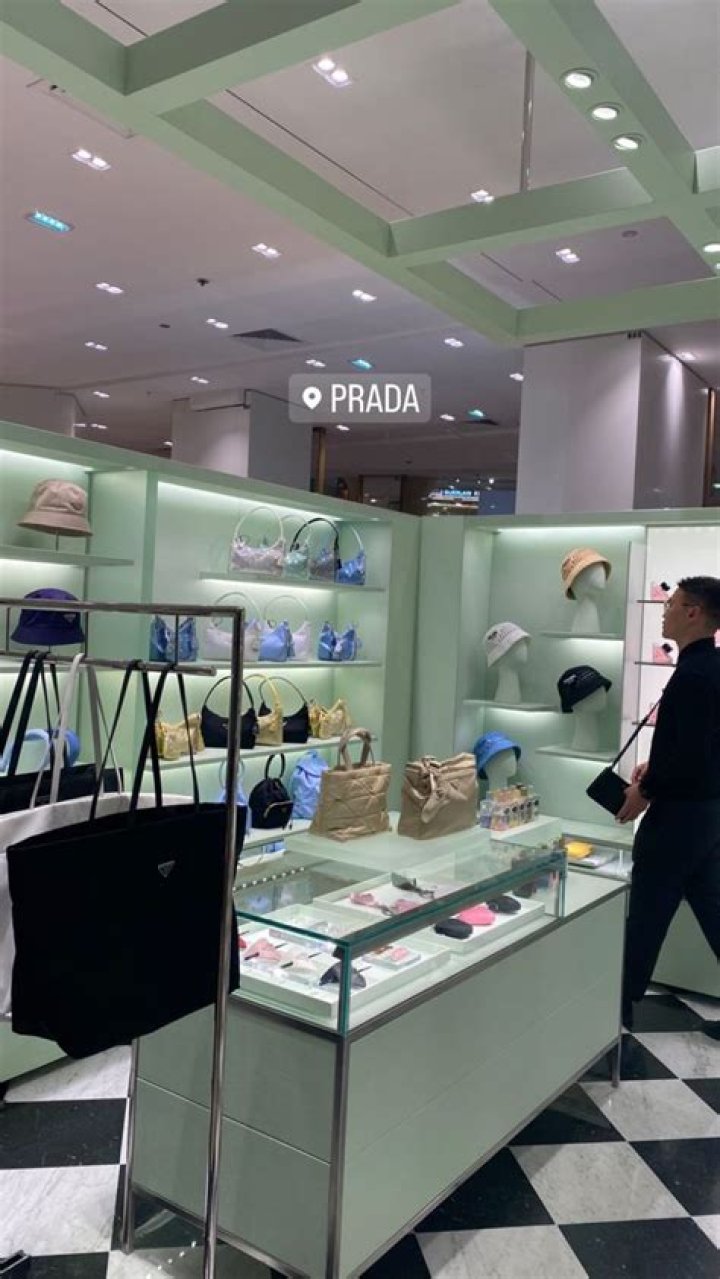 Paris showing off her Prada handbag alongside a Lamborghini and Merc