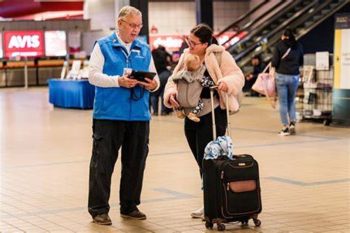 People are seen helping passengers out of the train cars