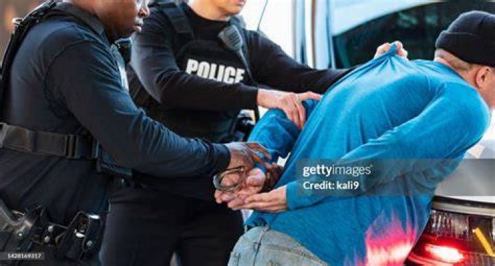 Photos shows police handcuffing suspects on the ground