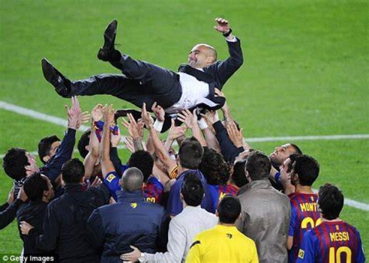 Players throw Pep in air after clinching Premier League title at Brighton last season