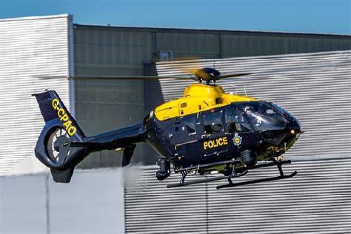 Police are seen above at the scene of the shooting on Christmas Day