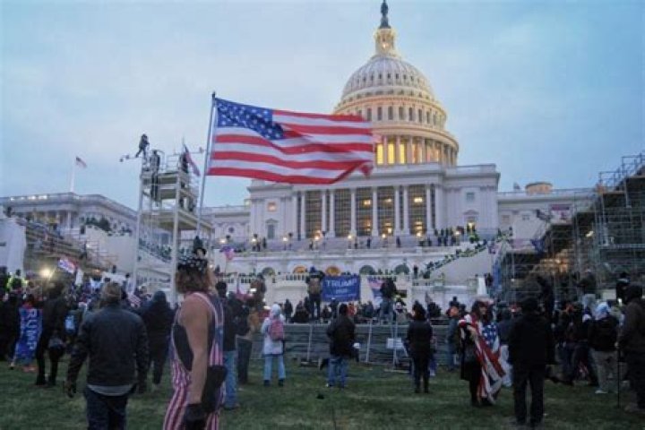 Police defend the Capitol building against pro-Trump rioters by using pepper spray