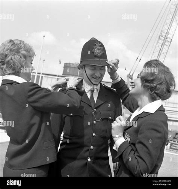  Police officers watch young British tourists at Punta Ballena, in Magaluf