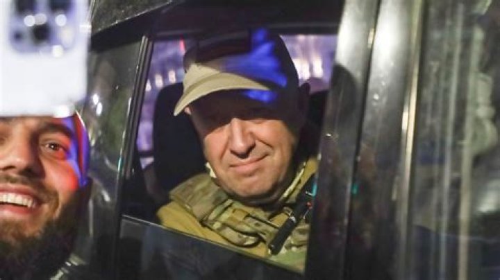 Prigozhin poses with a bottle of wine as he promoted his restaurant business