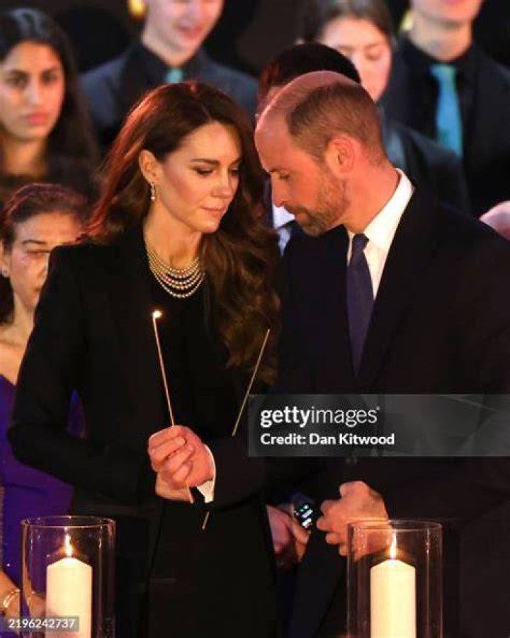 Prince William lights candles during the ceremony