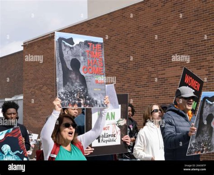 Protesters hold placards as they march during a demonstration to mark the International Day for the Elimination of Violence Against Women