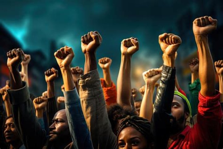 Protesters raised their arms in solidarity and said "who keeps us safe" "we keep us safe" outside the police building