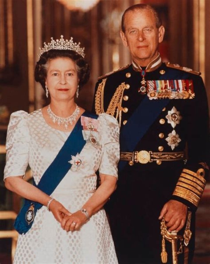 Queen Elizabeth II and Prince Phillip, Duke of Edinburgh sit for a photo with Watermen and Lightermen of the River Thames