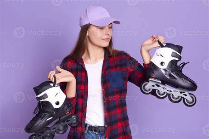 Ravae on rolling skates posing with a dog