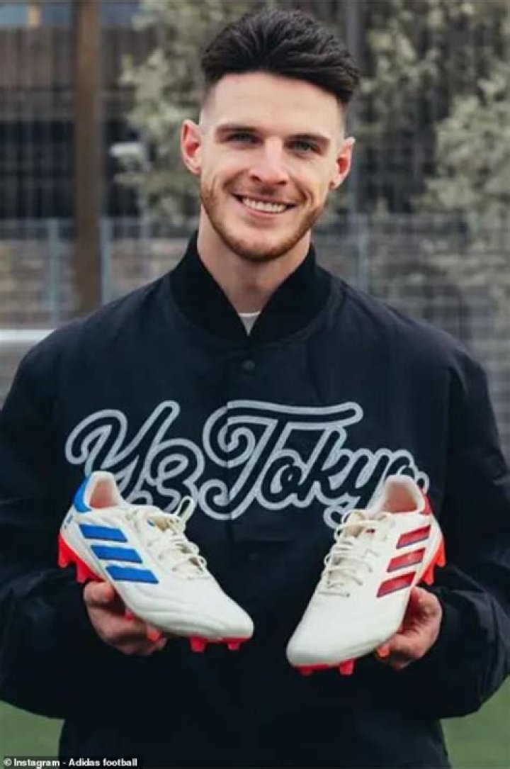 Rice, trying his boots on, is said to be a collector of football footwear himself