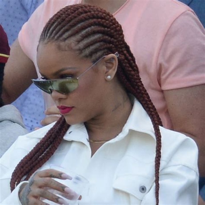 Rihanna stuns in cornrows hairdo and a sexy mini dress