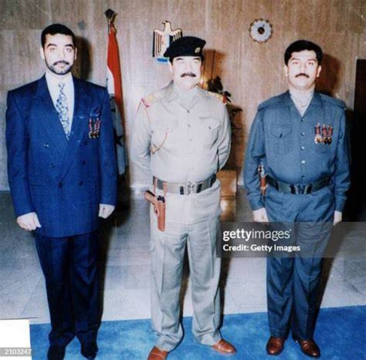 Saddam Hussein poses with his son Uday in 1988