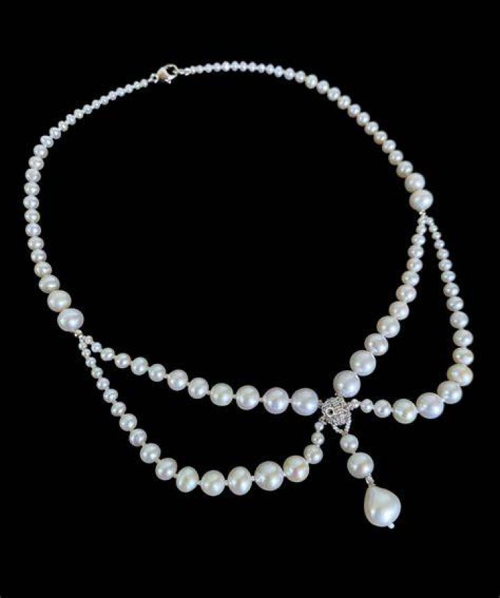 She draped a pearl necklace over her shoulders and clutched roses in one point during the photoshoot