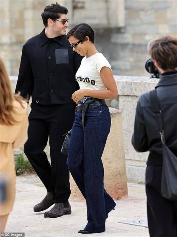 She grinned as she looked at the camera after exhaling and popping her bump back out