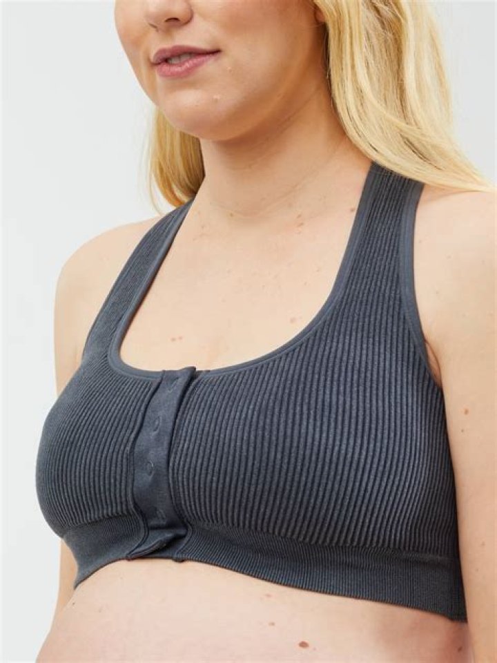 She wore a maternity bra as she cradled her one-year-old