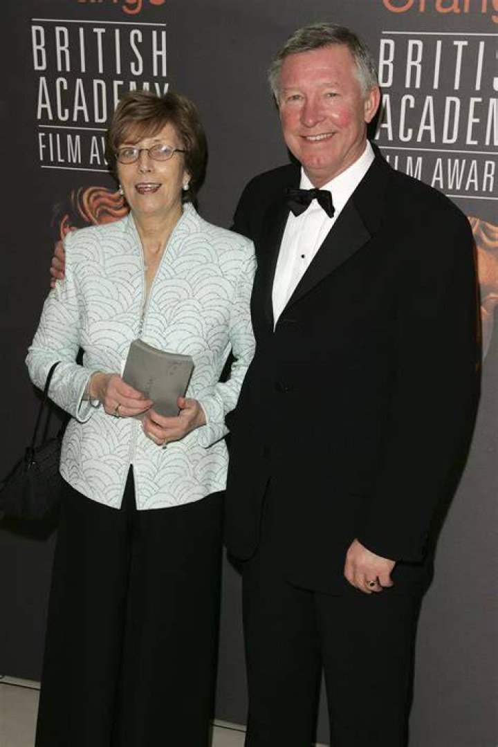 Sir Alex poses with Cathy after receiving a CBE at Buckingham Palace