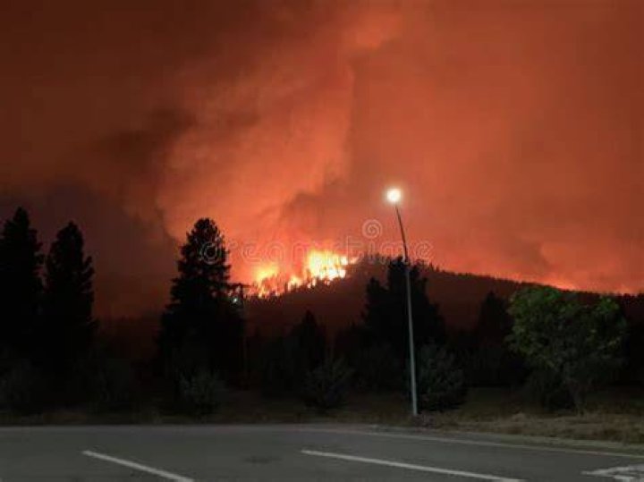 Smoke roared from the fire as first responders raced to contain the flames while enduring record heat
