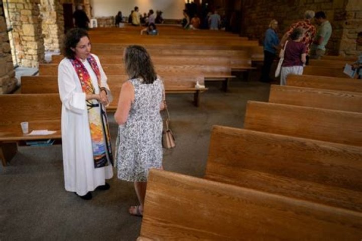  Spell talks to congregants after a service at Life Tabernacle Church