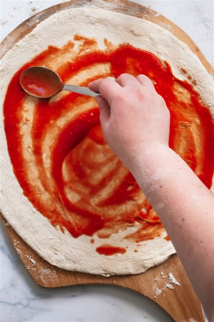  Spread your sauce starting from the centre going outwards, leaving roughly a 1cm gap
