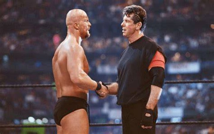 Stone Cold and Vince McMahon celebrating after Austin captured the WWE title from The Rock