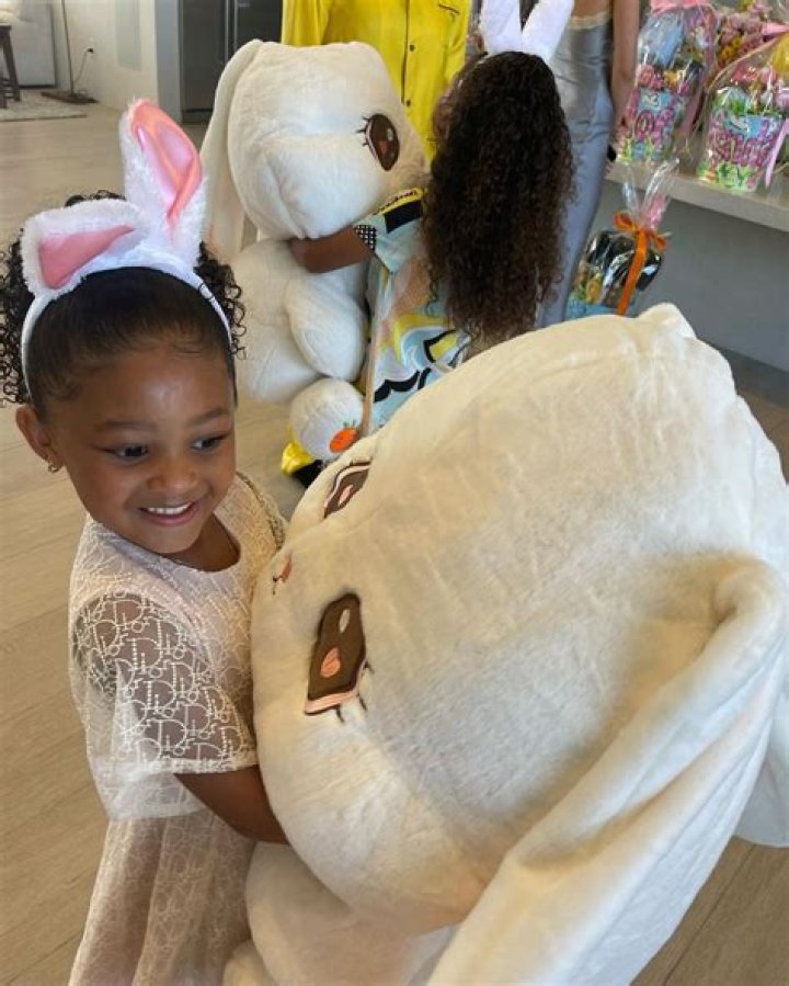 Stormi smiled big while holding a giant stuffed animal