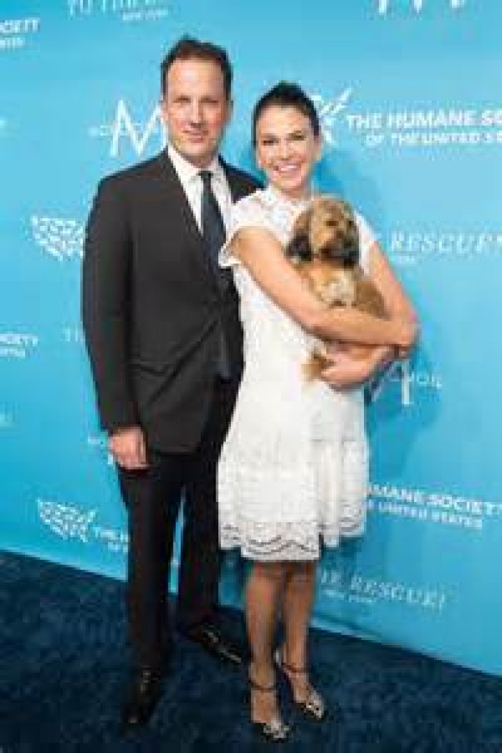 Sutton Foster and Ted Griffin are all smiles as they take a festive photo with their daughter Emily