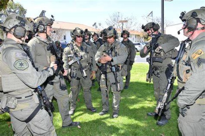 SWAT members join police officers outside Sonic