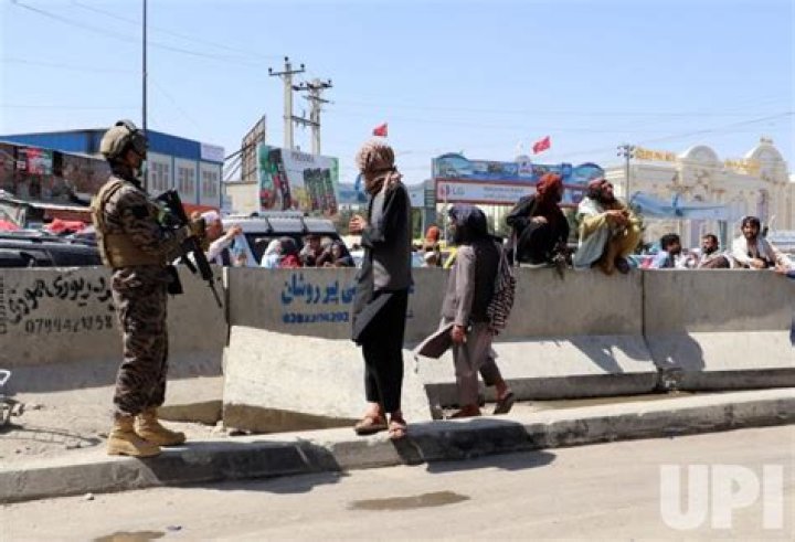Taliban fighters stand guard outside the Hamid Karzai International Airport today