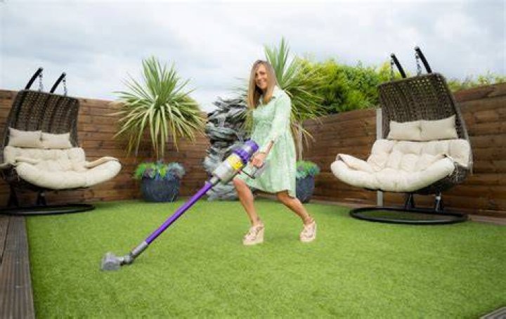 Teaching assistant Dawne Deeks uses a vacuum cleaner to keep her garden pristine