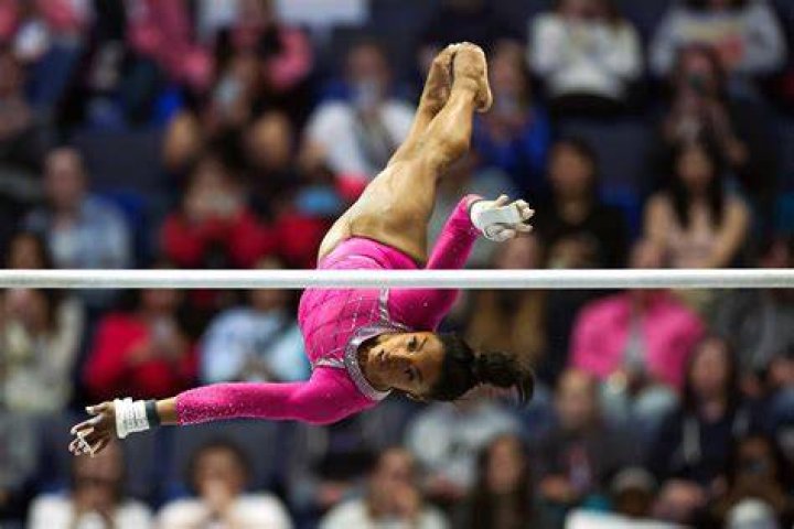 The 28-year-old gymnast showed off her tight abs and rock-solid legs in a sparkling blue bikini