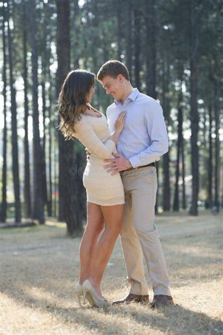 The couple engaged on the clifftop as passers-by were oblivious to the X-rated show below them