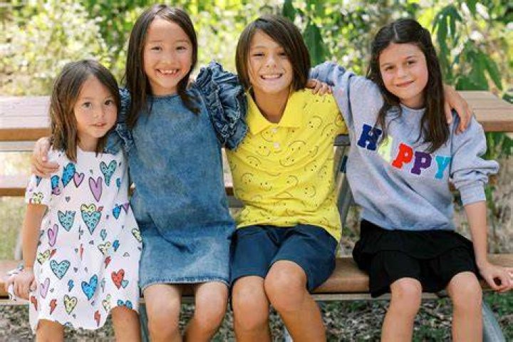  The four kids posed for a picture together next to a sign