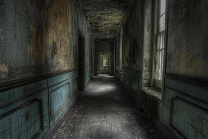 The hallways are abandoned as she is the only one there