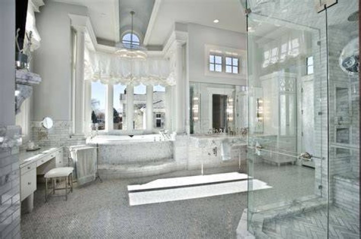 The huge master bath features a victorian tub and walk-in shower