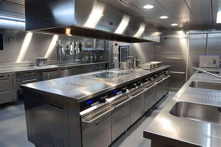  The kitchen features stainless steel appliances and white pantries