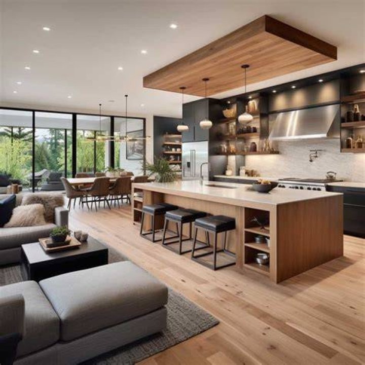 The living room and kitchen are surrounded by floor to ceiling glass windows and doors