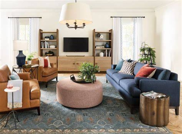  The living room has a stunning chandelier and white marble fireplace